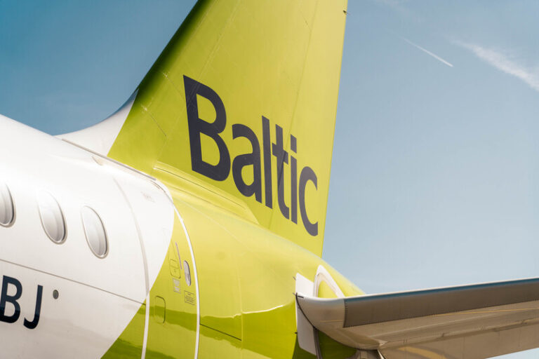 Rear view of a Baltic Airlines aircraft with a bright yellow tail and the word 'Baltic' visible on the fin.