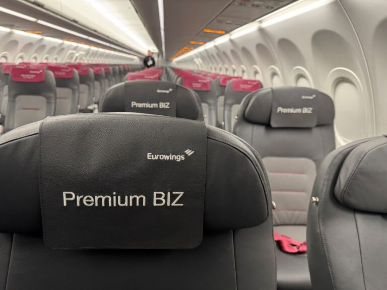 Interior of a Eurowings aircraft with premium business class seats, headrests reading 'Premium BIZ' and 'Eurowings' visible.
