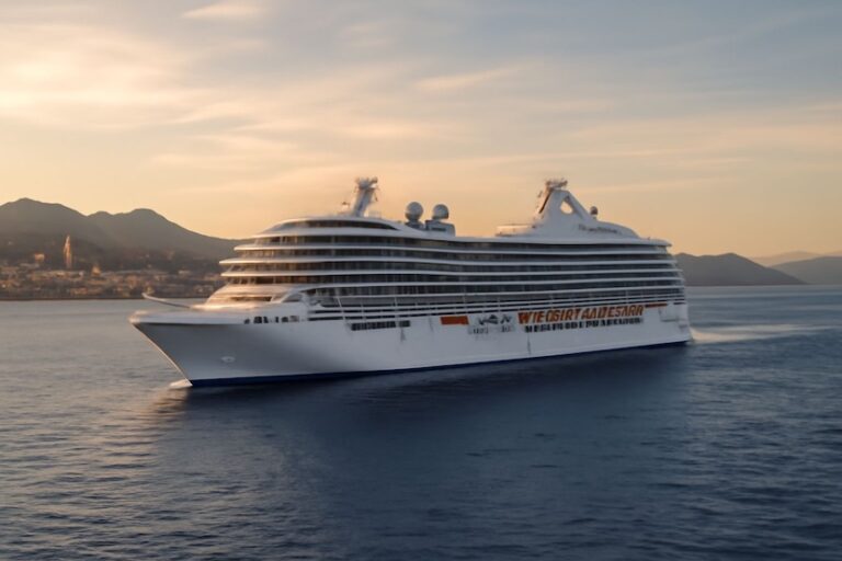 Large white cruise ship sailing on calm sea at sunset with distant mountains on the horizon.
