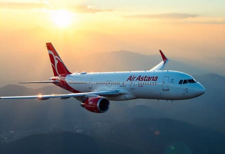 Air Astana passenger jet flying above mountains during sunset.