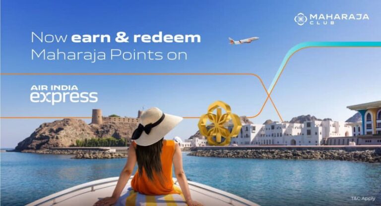 Woman in an orange dress and sunhat sits at the bow of a boat, looking toward a coastal town; banner text reads 'Now earn & redeem Maharaja Points on Air India Express' with a Maharaja Club logo in the corner.
