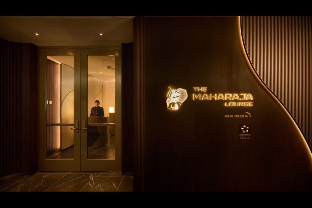Entrance to The Maharaja Lounge with glass doors; a staff member sits at the reception inside.