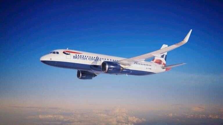 British Airways passenger jet flying above clouds against a bright blue sky.