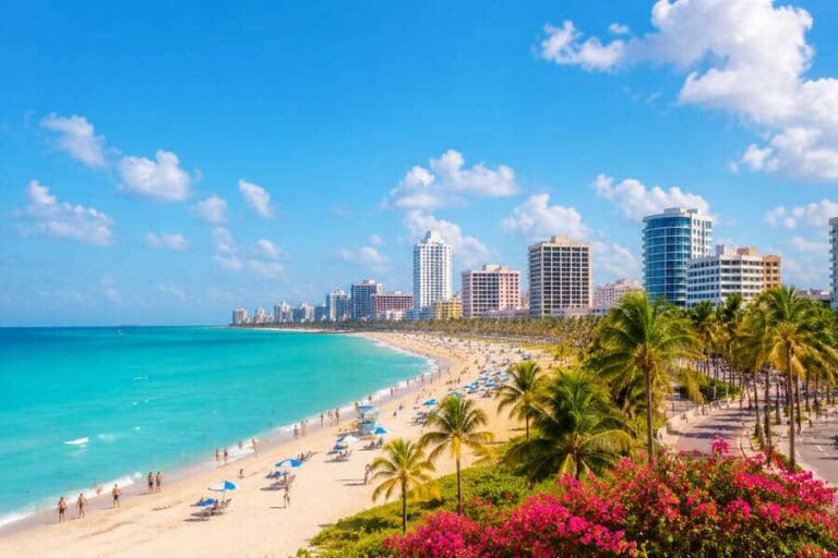 Sunny tropical beach with turquoise water, palm trees, and high-rise hotels along a sandy shoreline.