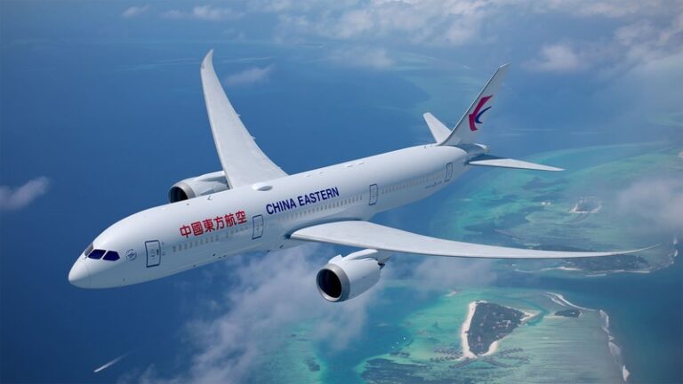 White China Eastern Airbus A350 flying over turquoise coastlines and islands, blue sky with light clouds in the background.