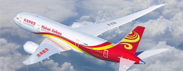 Hainan Airlines passenger jet flying above clouds, colorful red-yellow livery visible on fuselage and tail