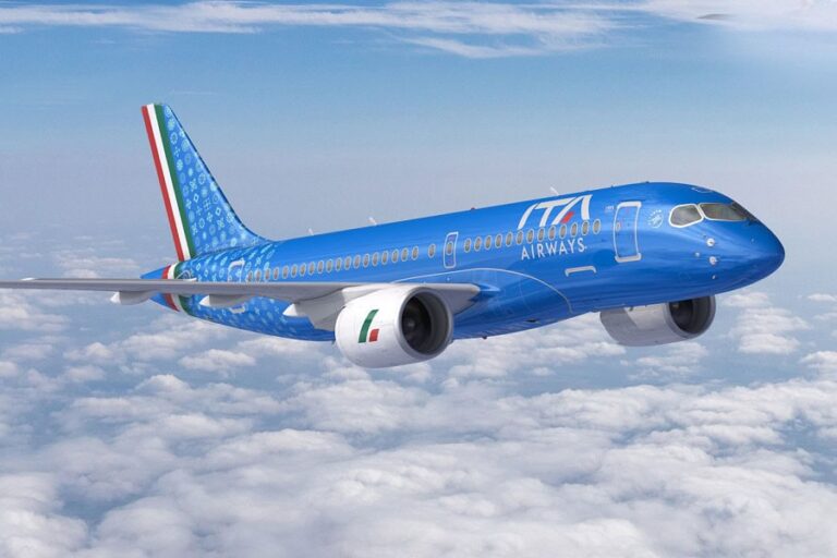 Blue ITA Airways jet flying above cloudy sky with an Italian flag on the tail, midflight.