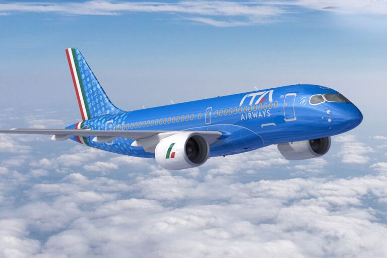 Blue commercial airplane in flight above a blanket of white clouds, with Italian flag accents on tail and engines.