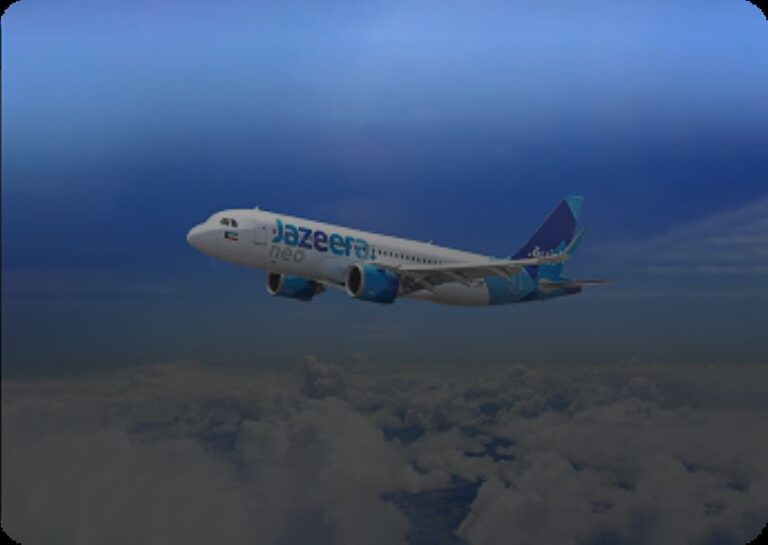 White commercial airplane with blue engines flying above clouds, 'Jazeera' branding on the fuselage.