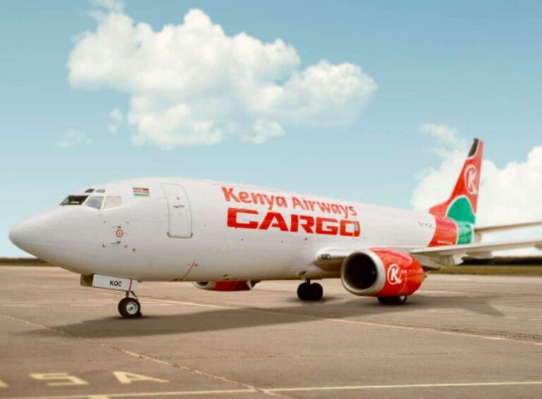 Kenya Airways Cargo jet parked on an airstrip under a blue sky with scattered clouds, front view side profile shown