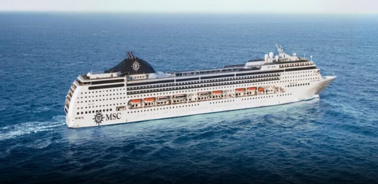 MSC cruise ship sailing on the open blue ocean, with multiple decks and orange lifeboats along the side