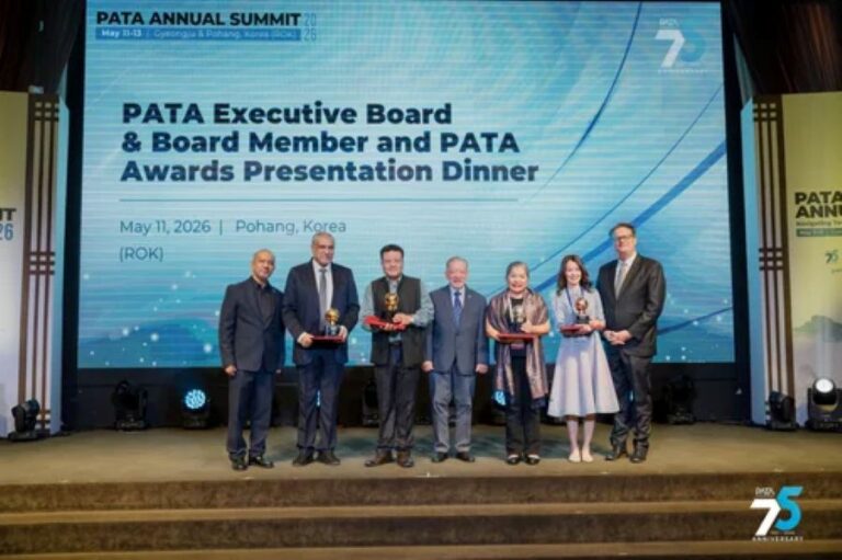 Group of seven people on a stage receiving awards at the PATA Annual Summit 2026 in Pohang, Korea, with a large screen backdrop showing event title.