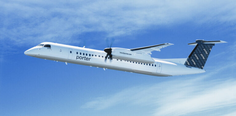 Porter Airlines turboprop aircraft in flight against a clear blue sky