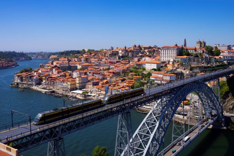 Porto, Portugal: Dom Luís I Bridge over the Douro River with red-roofed buildings on the hillside.