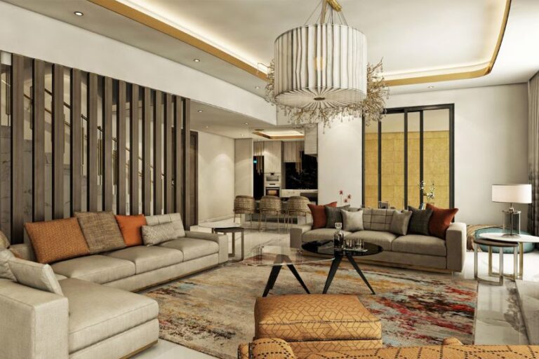 Luxurious open-plan living room with beige modular sofas, a large chandelier, and a colorful area rug with a glass coffee table in the center.