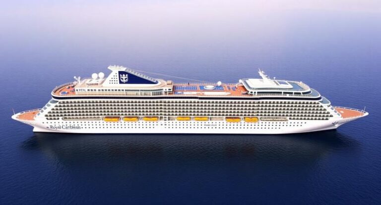 Royal Caribbean cruise ship sailing on calm blue ocean with multiple decks and yellow lifeboats on the side of the vessel