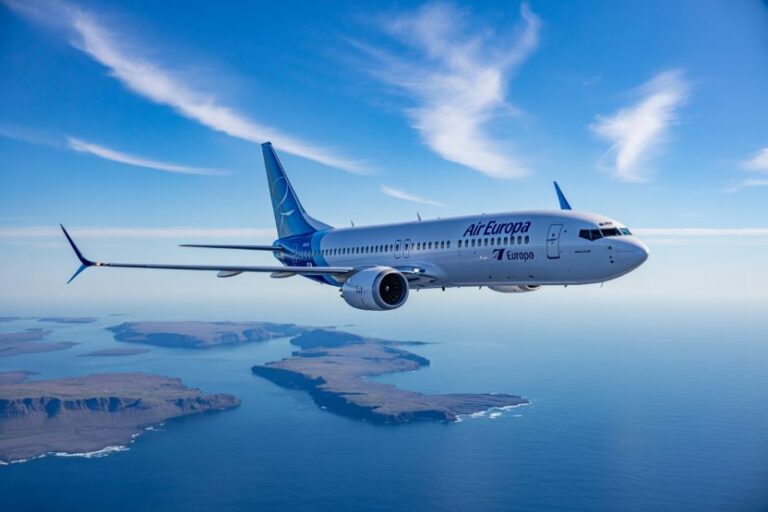 Air Europa passenger plane flying over blue water and islands under a clear sky