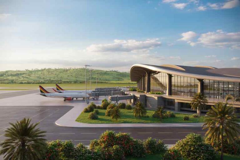 Modern airport terminal with glass facade, palm trees, and parked airplanes on the tarmac.
