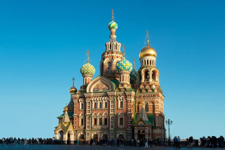 Saint Basil's Cathedral in Moscow with colorful onion domes and a clear blue sky behind it.