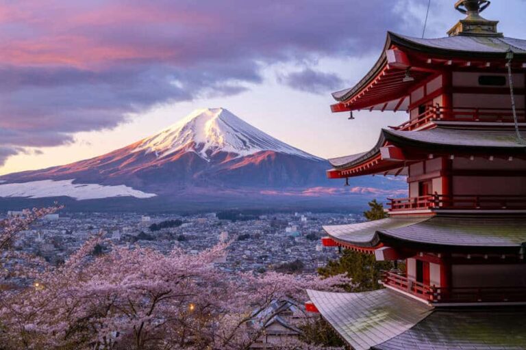 Chureito Pagoda on the right with Mt. Fuji and blooming cherry blossoms in spring.