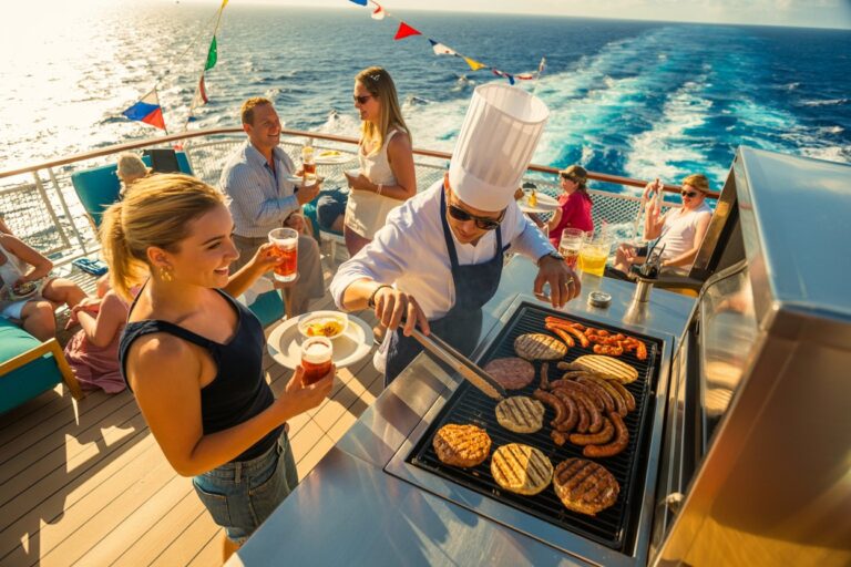 People on a cruise deck grilling burgers and sausages while others socialize with drinks, ocean in the background