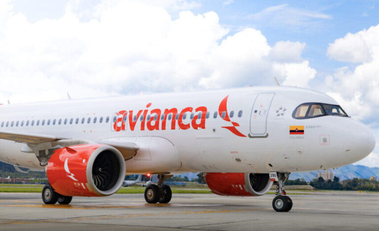 Avianca passenger jet on the runway, white fuselage with red Avianca logo and red engine nacelles.