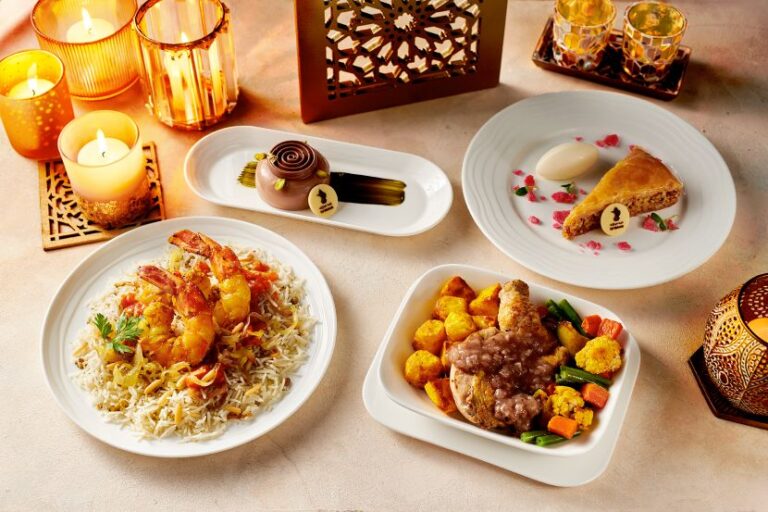 Assorted plated dishes on a candlelit table: shrimp fried rice, beef and vegetable bowl, and a slice of pie with dessert on the side.