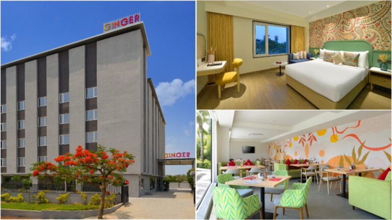 Ginger hotel exterior with sign and entrance, with a landscaped foreground and blue sky.