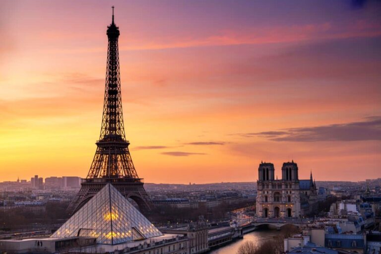 Sunset over Paris with the Eiffel Tower beside the Louvre Pyramid along the Seine time of day sunset and warm sky colors