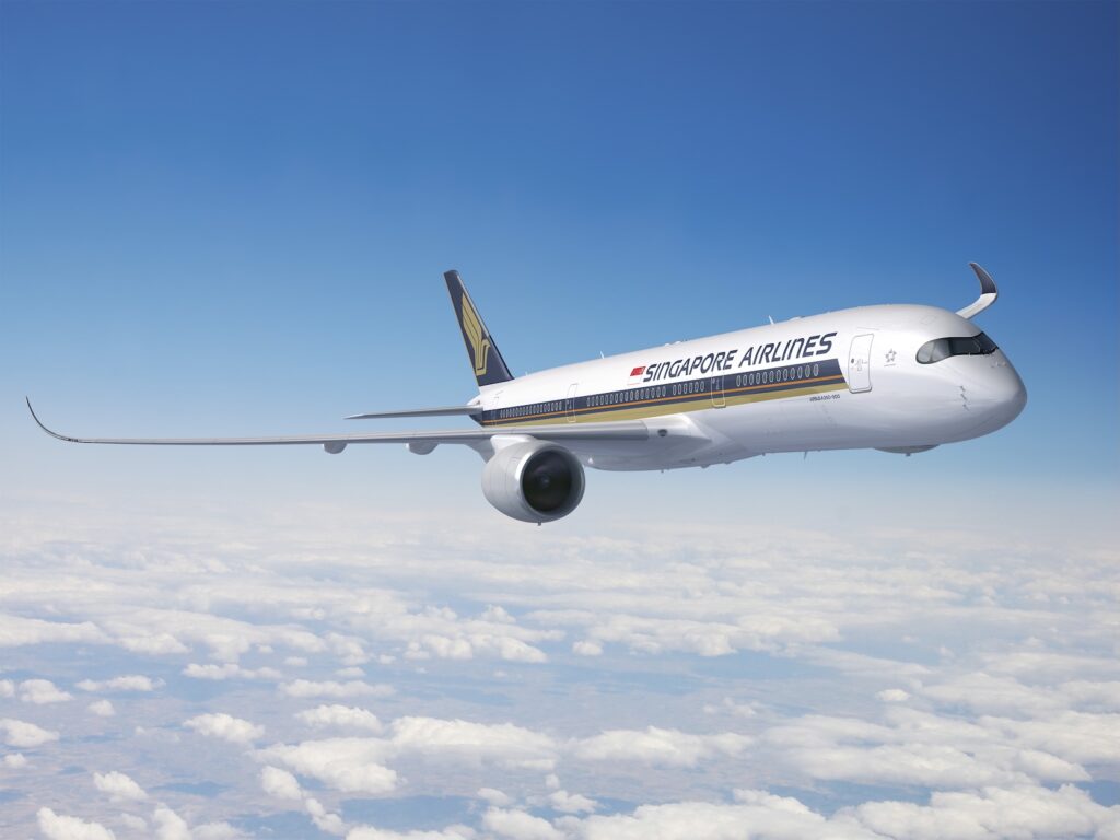 Singapore Airlines jet soaring above clouds with blue sky, showing the airline branding on the fuselage and tail fin