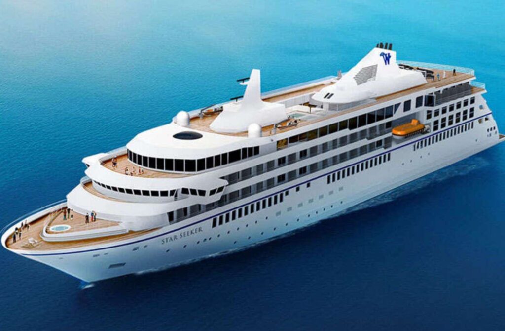 White cruise ship named Star Seeker sailing on calm blue ocean.