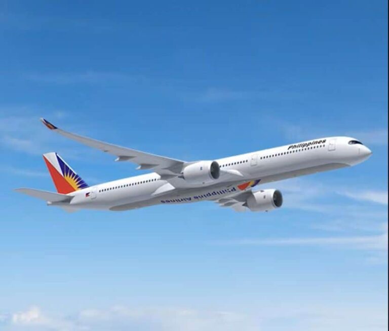 Philippine Airlines jet in a clear blue sky, midflight with logo on tail and engines visible