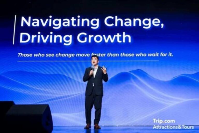 Male speaker on a blue stage backdrop with the title 'Navigating Change, Driving Growth' and the subtitle 'Those who see change move faster than those who wait for it.' Trip.com Attractions & Tours logo in the corner.