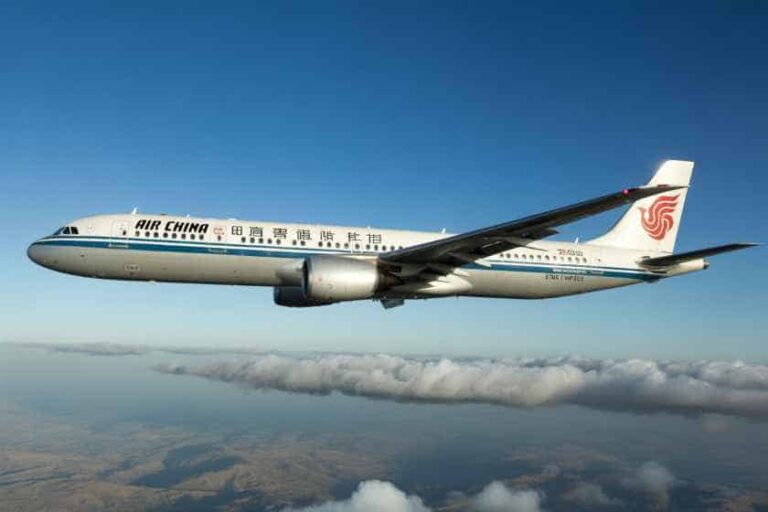 Air China passenger jet flying over clouds with a clear blue sky behind it, mid-flight in formation
