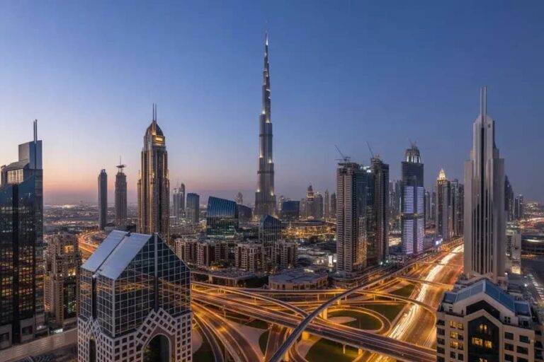 Dubai skyline at dusk featuring the Burj Khalifa and illuminated skyscrapers.