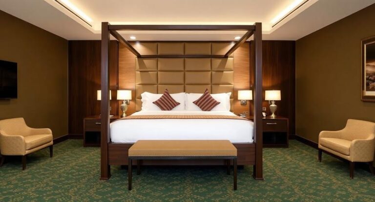 Luxurious hotel room with a dark wood four-poster bed, upholstered headboard, two nightstands with lamps, and a green patterned carpet.