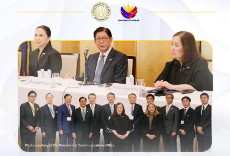 Three officials seated at a panel desk with microphones, while a larger group of officials stands in front for a formal group photo; government logos visible above.
