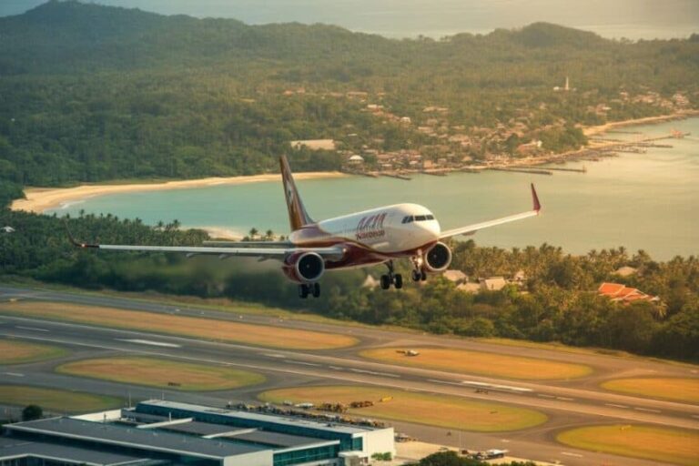 A commercial jet on final approach to a runway, with a coastal bay and lush hills in the background.