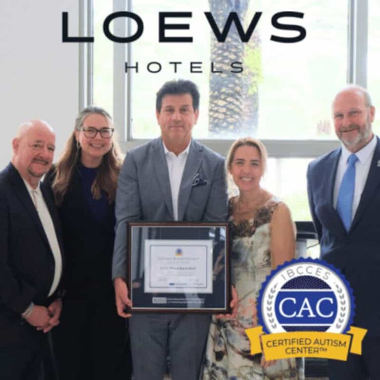 Five professionals pose with a framed certificate in a hotel lobby; LOEWS HOTELS logo visible above.