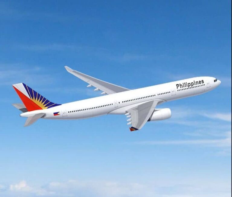 White commercial airplane with Philippines branding flying in a clear blue sky, side view showing tail with colorful Philippine flag design and the word 'Philippines' on the fuselage.